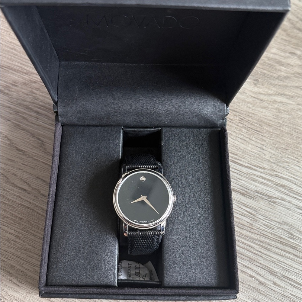 Movado black face minimalistic leather watch.